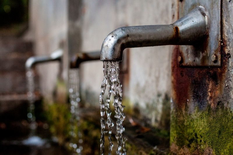 Tap water pouring from faucets