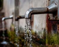 Tap water pouring from faucets