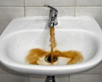 bathroom sink dispensing brown colored water